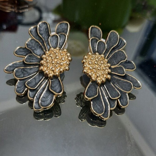 Metal earrings with black enamel and gold details, half flower design