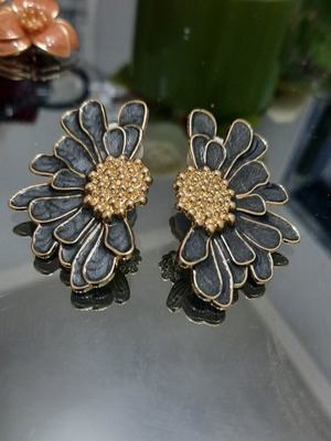 Metal earrings with black enamel and gold details, half flower design