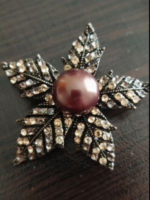 Brown flower-shaped pin with stones like new