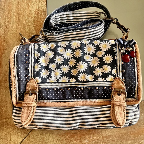 Accessorize vintage crossbody bag with daisies and cherries
