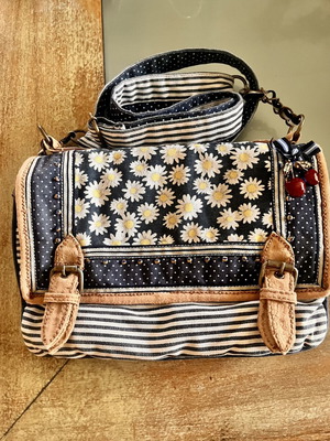Accessorize vintage crossbody bag with daisies and cherries