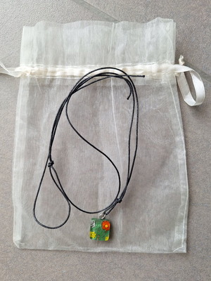 Necklace pendant with green floral design