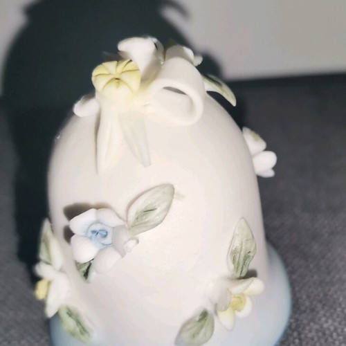 Ceramic bell used with embossed flower designs