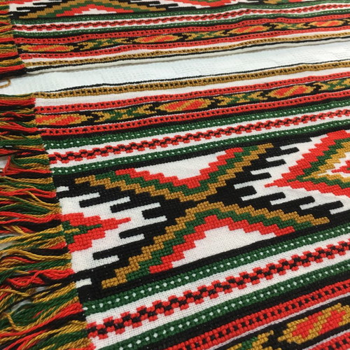 Set of handmade cross-stitch table runners with geometric patterns