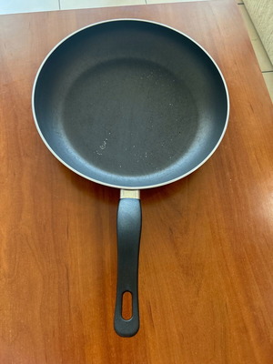 Large deep frying pan used with wear on the bottom