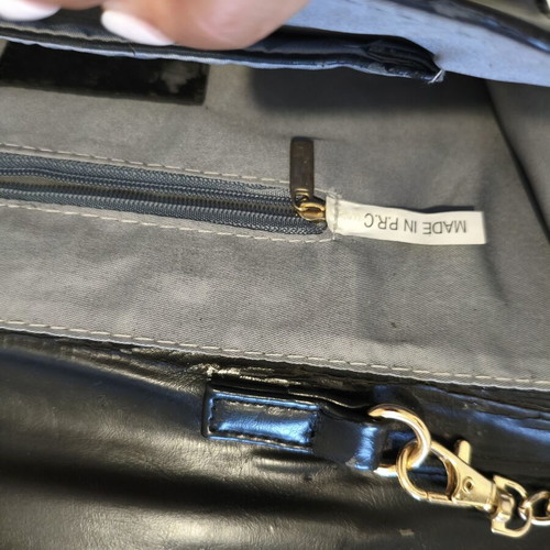 Black clutch bag with gold chain used, synthetic leather