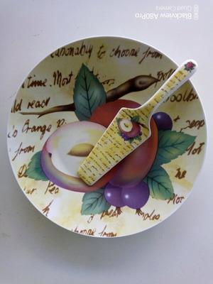 Ceramic serving platter with matching spatula, fruit design