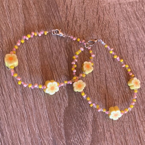 Friendship bracelets set with yellow and pink flowers made to order