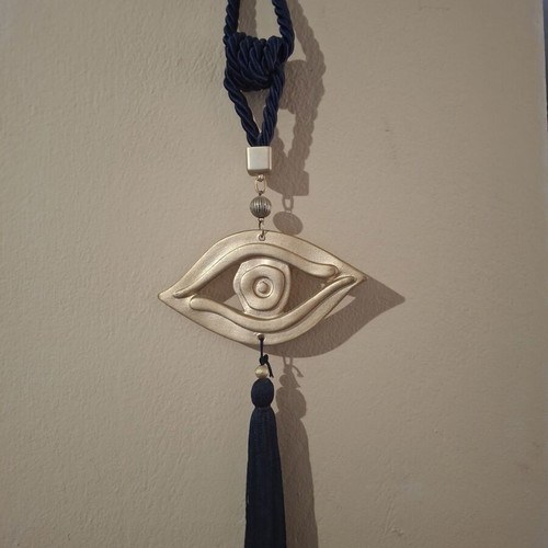 Decorative hanging eye ceramic with tassel in blue and gold tones like new