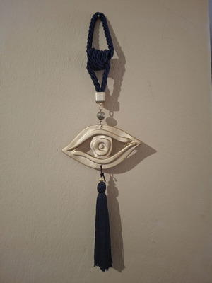 Decorative hanging eye ceramic with tassel in blue and gold tones like new