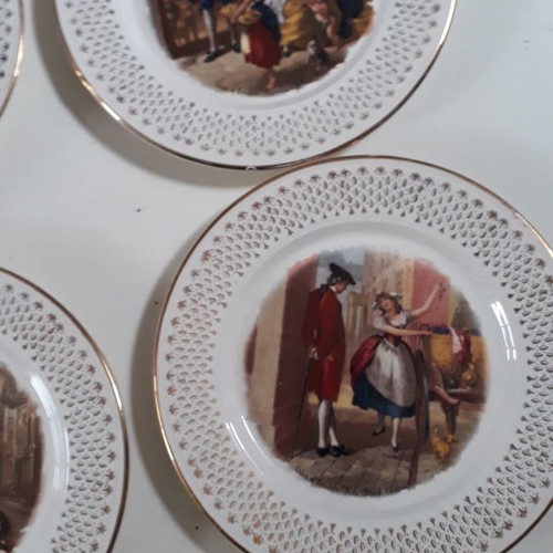 Set of four used French wall plates with gold designs 23cm