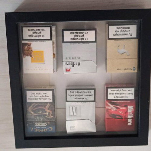 Frame with used collectible cigarette packs