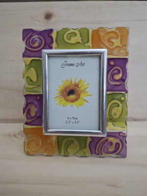 Glass photo frame with embossed orange, olive and purple designs