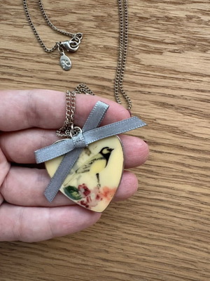 Accessorize long heart necklace with bird design and fabric bow like new
