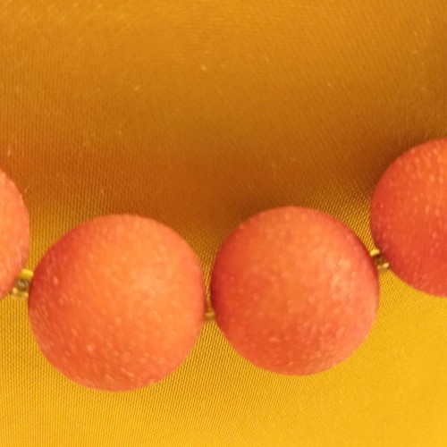 Orange-red necklace with textured stones used