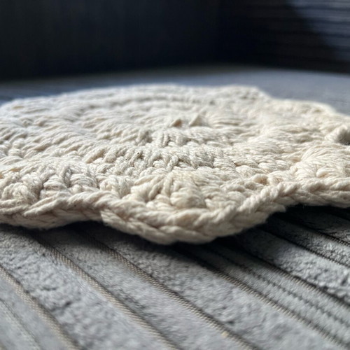 Knitted coaster used, flower-shaped, beige