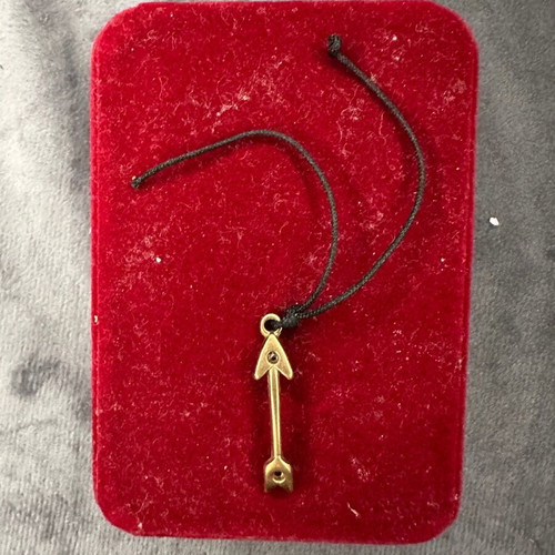 Arrow pendant necklace used with black cord and gold detail
