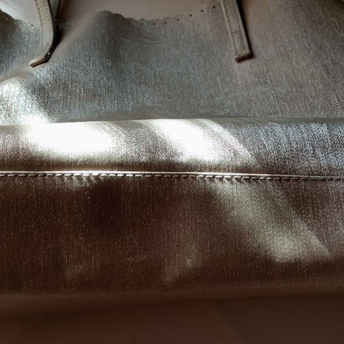 Women's shoulder bag metallic silver with flower cutouts