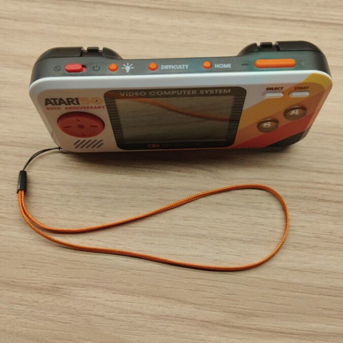 Atari Pocket Player Pro handheld console with games and box