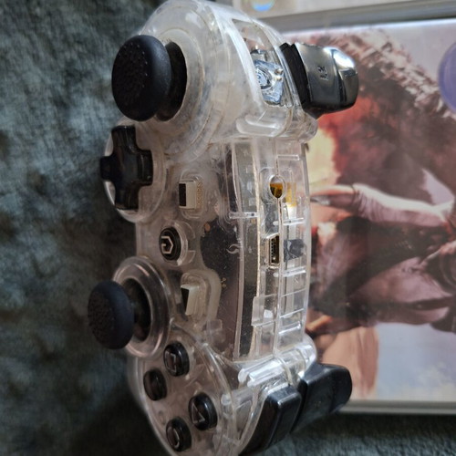 PlayStation 3 games pack with 7 titles and transparent controller like new