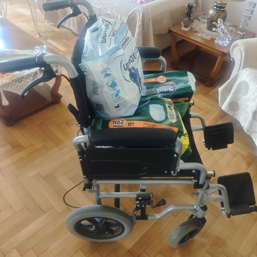Folding wheelchair with handbrake and footbrake