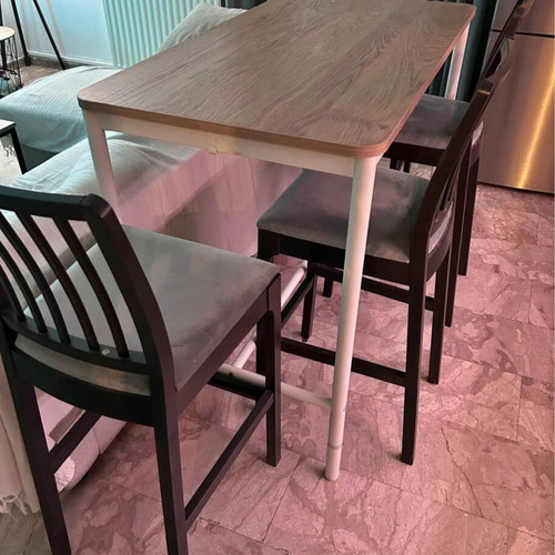 Bar-style dining set with wooden table and 4 grey fabric stools