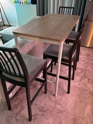Bar-style dining set with wooden table and 4 grey fabric stools