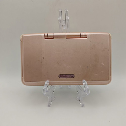 Nintendo DS pink handheld console used with charger and stylus