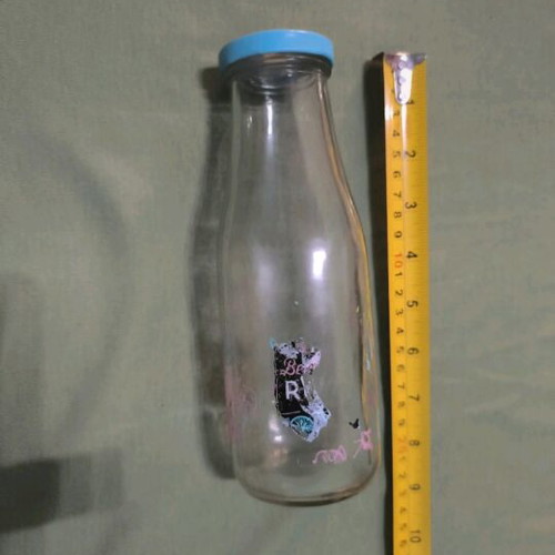 Glass water bottle used with hole for straw